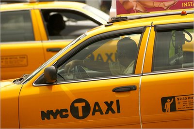 A taxi driver uses a hands-free device despite ban