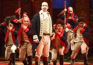 Lin Manuel Miranda on stage on Broadway performing Hamilton