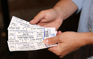 Person holding three tickets for Hamilton on Broadway